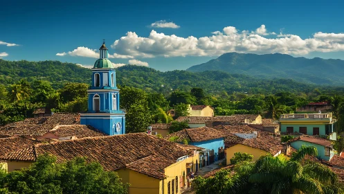 Colonial town rooftops under lush mountain skyline.