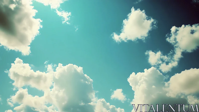 Sunlit cumulus clouds drift gently across a tranquil sky