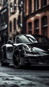 Black convertible sports car parked on wet urban street.