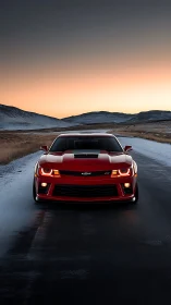 Red sports car powers through a frozen road at sunrise