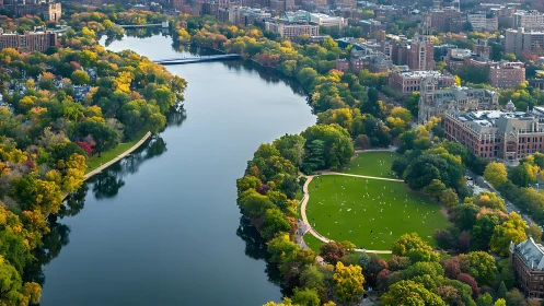 Riverfront city park curves through vibrant autumn foliage.