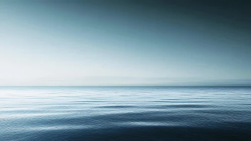 Calm blue ocean horizon under clear gradient sky scene.