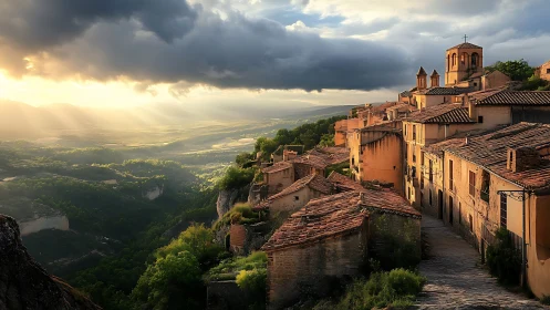 Sunlit hilltop village overlooking dramatic green valley.