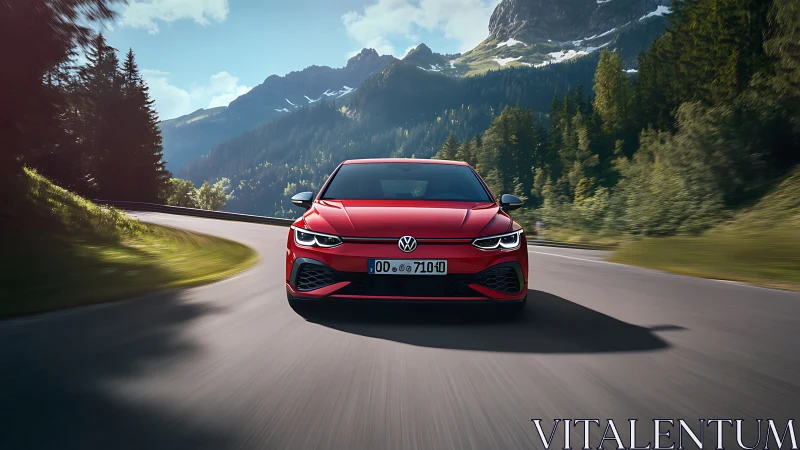 Bright red hatchback enjoys a sweeping mountain road drive