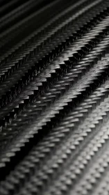 Carbon fiber weave texture with diagonal glossy pattern.