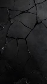 Fractured black stone surface with minimal geometric texture.