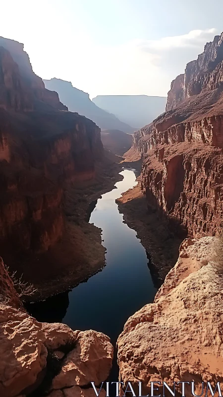 High-walled sandstone canyon with narrow reflective river gorge