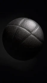 Monochrome close-up of basketball under directional light.