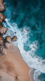 Turquoise waves curl onto a rocky sand shore at golden dusk