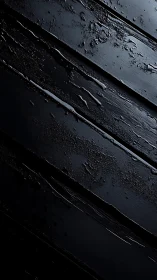 Moody black wooden planks glistening with soft water trails.