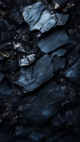 Layered slate rock slabs form dense dark mineral wall