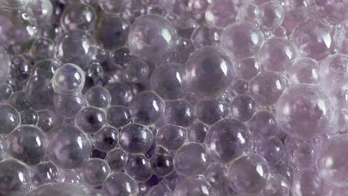 Lavender soap galaxies drift in a glimmering bubble nebula