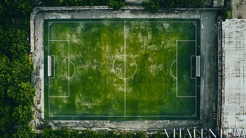 Lonely urban football pitch waits calmly between wild and rust