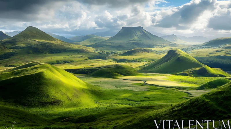 Green upland valley with isolated mesas under cloud cover.