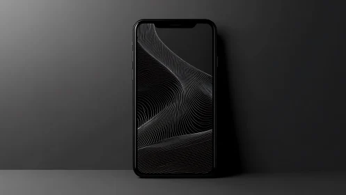 Black smartphone with abstract line display on dark surface.