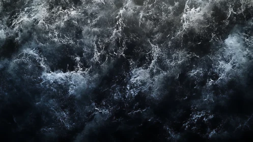 Storm-tossed dark ocean surface seethes under moody skies