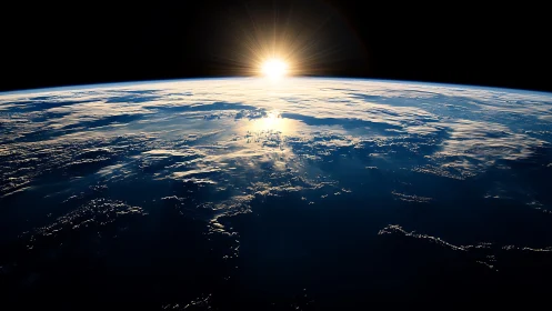 Orbital sunrise over Earth with luminous cloud formations.