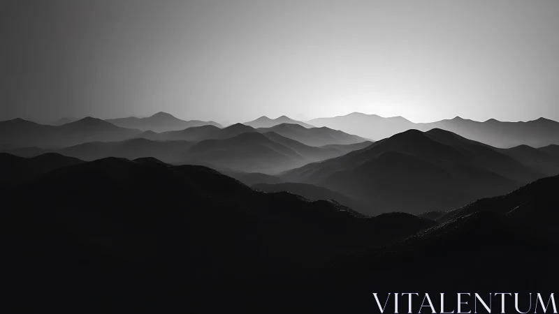 Monochrome mountain ridges in layered atmospheric backlight.