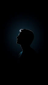 Silhouette profile of a man isolated against dark background