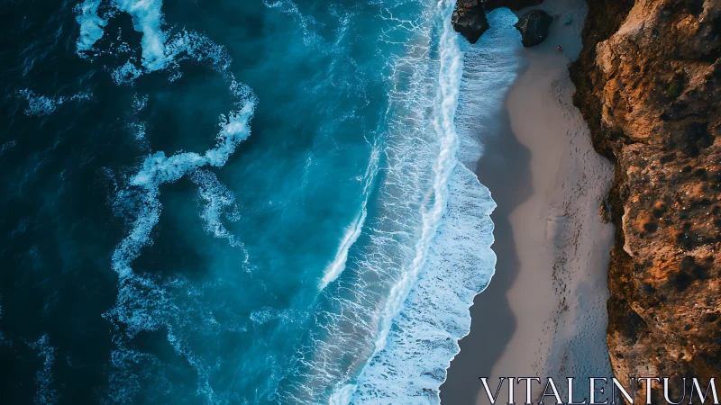 Drone view shows waves breaking along rugged coastal cliff