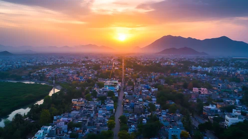Sunset light washes a sprawling city beneath distant hills