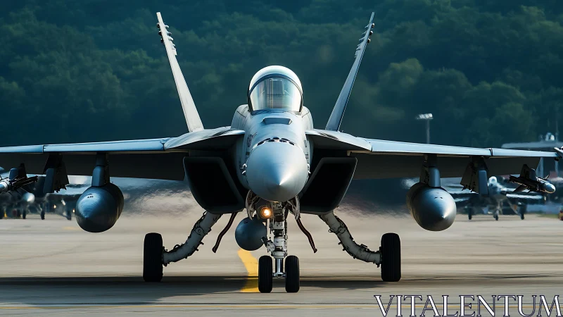 Twin-engine fighter jet taxiing on runway in frontal view.
