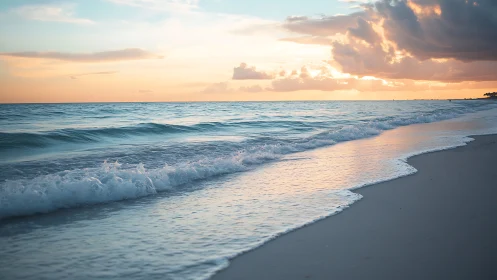 Coastal shoreline captures low surf under layered sunset sky
