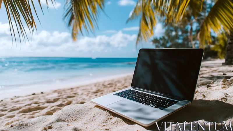 Laptop sits on tropical beach sand under palm fronds