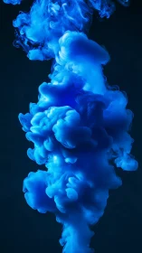 Electric cyan ink plume ascends in high-contrast liquid field