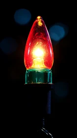 Macro close-up of illuminated red C7 holiday bulb filament