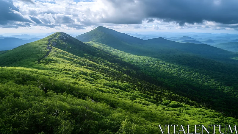 Ridge-line mountain panorama under dramatic stratified storm clouds