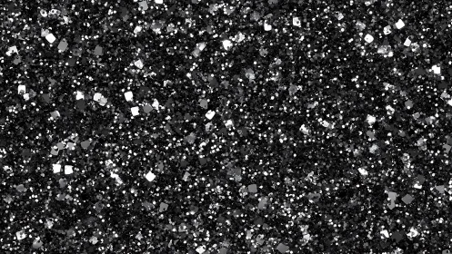 Black and silver glitter granules create dense reflective field