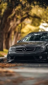 Glossy black Mercedes front profile under shallow depth of field