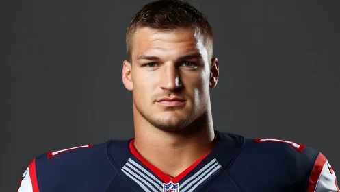 Football player portrait in dark uniform studio shot.