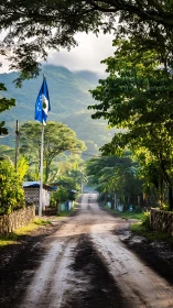 Morning mist crowns a rural road beneath emerald hills