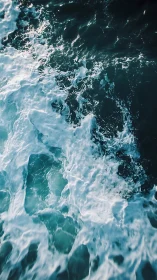 Overhead view of turbulent teal sea surface patterning.