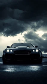 Black sports car on wet road under dark storm clouds.