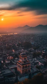 Sunset over historic tower and misty cityscape panorama.