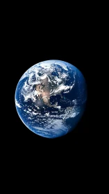 Solitary blue Earth suspended in deep cosmic blackness.