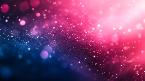 Vibrant pink and blue bokeh abstract background with glitter effect.