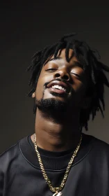 Relaxed glow and quiet confidence in a golden chain portrait.