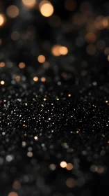 Black surface with golden bokeh lights in soft focus