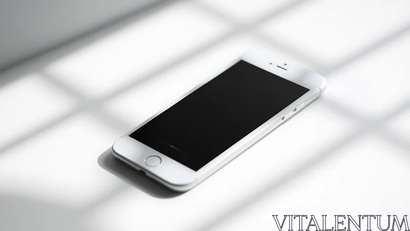 White iPhone with Black Screen on Sunlit Surface.