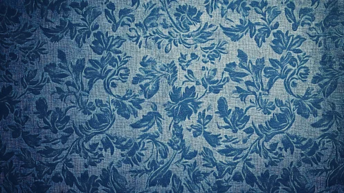 Blue floral textile surface with repeating damask pattern.