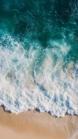 Turquoise waves roll onto soft sand in a tranquil seascape.