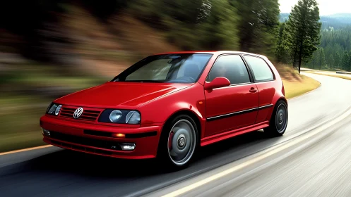 Red compact hatchback car driving quickly on curved forest road.