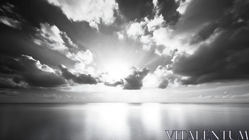 Gentle monochrome sunrise spilling light across calm sea.