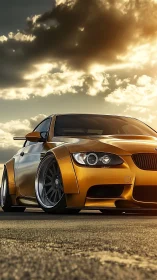 Golden widebody sports coupe glows under dramatic sunset sky.