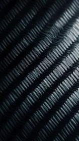 Close macro view of dark diagonal woven textured surface.
