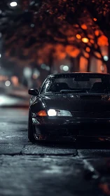 Low-slung tuner car idles under bokeh streetlights at night